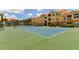 Well-maintained tennis court in a landscaped community with vibrant buildings in the background at 10764 70Th Ave # 2110, Seminole, FL 33772
