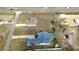 Aerial view of a Gathering home, highlighting the pool, long driveway and surrounding landscape at 11040 Flicker Rd, Brooksville, FL 34613