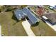 Aerial view of a landscaped property with a screened pool, long driveway and mature trees at 11040 Flicker Rd, Brooksville, FL 34613