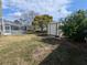 The home's backyard features a storage shed and screened-in pool area at 11040 Flicker Rd, Brooksville, FL 34613