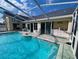 Private backyard showcasing the sparkling pool, outdoor kitchen, and patio area at 11040 Flicker Rd, Brooksville, FL 34613