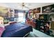 Spacious bedroom features a ceiling fan, blue carpet, and many posters of the band Rush on the walls at 11040 Flicker Rd, Brooksville, FL 34613
