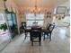 Bright dining area featuring tile floors, a chandelier, and views of the outdoor pool at 11040 Flicker Rd, Brooksville, FL 34613