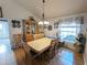 Charming dining area featuring wood flooring, a large window, and elegant decor at 11040 Flicker Rd, Brooksville, FL 34613