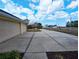 Long driveway leads to a spacious two car garage under a sunny sky at 11040 Flicker Rd, Brooksville, FL 34613