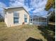 The home's exterior features a screened-in pool area and awnings over the windows for shade at 11040 Flicker Rd, Brooksville, FL 34613