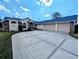 Spacious home with large driveway, 3-car garage, and brick and stucco exterior at 11040 Flicker Rd, Brooksville, FL 34613