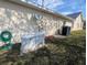 Exterior view of house featuring a generator, AC unit, and a lush lawn at 11040 Flicker Rd, Brooksville, FL 34613