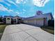 Charming single-story home with a well-manicured lawn and a long driveway leading to a two car garage at 11040 Flicker Rd, Brooksville, FL 34613