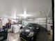 Organized two-car garage space features a car, washer, dryer, and storage shelving at 11040 Flicker Rd, Brooksville, FL 34613