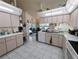 Open kitchen featuring white cabinetry, stainless steel sink and updated appliances at 11040 Flicker Rd, Brooksville, FL 34613