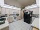 Bright kitchen with white cabinets, appliances, and ample counter space at 11040 Flicker Rd, Brooksville, FL 34613