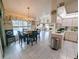 Bright and airy kitchen with breakfast bar and view into dining and living area at 11040 Flicker Rd, Brooksville, FL 34613