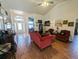 Inviting living room with high ceilings, wood-look tile flooring, and plenty of natural light at 11040 Flicker Rd, Brooksville, FL 34613