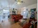 Spacious living room featuring wood-look flooring, vaulted ceiling, and an open layout at 11040 Flicker Rd, Brooksville, FL 34613