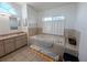 Bright main bathroom featuring double sinks, large tub, and a shower at 11040 Flicker Rd, Brooksville, FL 34613