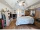 Large main bedroom with tray ceilings, ceiling fan, hardwood floors and ensuite bathroom at 11040 Flicker Rd, Brooksville, FL 34613