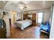Large main bedroom with tray ceilings, ceiling fan, hardwood floors and ensuite bathroom at 11040 Flicker Rd, Brooksville, FL 34613