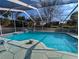 Sparkling screened-in pool and spa, featuring plenty of room for outdoor lounging at 11040 Flicker Rd, Brooksville, FL 34613