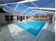 Beautifully maintained screened-in pool and patio with a view of the home's exterior at 11040 Flicker Rd, Brooksville, FL 34613