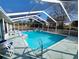 Relaxing pool and spa area with a screened enclosure and comfortable outdoor seating at 11040 Flicker Rd, Brooksville, FL 34613