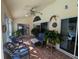 Spacious sunroom with tile flooring, comfortable seating, and view of the pool and backyard at 11040 Flicker Rd, Brooksville, FL 34613