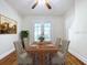 Elegant dining room with hardwood floors, a classic dining set, and french doors to the backyard at 1276 Sedeeva N Cir, Clearwater, FL 33755