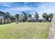 View of the backyard, showcasing a well-maintained lawn, trees and wooden fence at 1370 70Th N St # 2-1382, St Petersburg, FL 33710