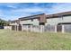 View of the backyard, showcasing a row of townhomes with a well-maintained lawn at 1370 70Th N St # 2-1382, St Petersburg, FL 33710