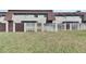 Townhome backyard featuring a grassy area and a wooden fence at 1370 70Th N St # 2-1382, St Petersburg, FL 33710