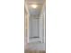 Hallway featuring carpet floors and multiple white doors, perfect for privacy at 1370 70Th N St # 2-1382, St Petersburg, FL 33710