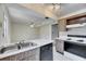Kitchen featuring stainless steel sink, dishwasher, and a view into the adjacent living area at 1370 70Th N St # 2-1382, St Petersburg, FL 33710