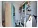 View of storage space containing an old refrigerator, shelves, and a ladder at 1370 70Th N St # 2-1382, St Petersburg, FL 33710