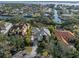 Aerial view of a stunning home surrounded by lush landscaping and situated on a canal with easy access to the bay at 1724 Amberwynd W Cir, Palmetto, FL 34221