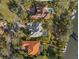 Aerial view showcasing multiple waterfront homes, swimming pools, boat docks, and lush landscaping at 1724 Amberwynd W Cir, Palmetto, FL 34221