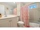 Bathroom showcasing a tub and shower combination, vanity, mirror, and decorative shower curtain at 1724 Amberwynd W Cir, Palmetto, FL 34221