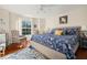 Bedroom with a blue patterned comforter, checked armchairs and light filled window at 1724 Amberwynd W Cir, Palmetto, FL 34221