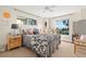 Bedroom featuring a queen bed, natural lighting, and decorative seahorse themed decor at 1724 Amberwynd W Cir, Palmetto, FL 34221