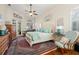 Cozy main bedroom with a king bed, ceiling fan, and private access to an outdoor balcony at 1724 Amberwynd W Cir, Palmetto, FL 34221