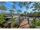 Private boat dock and lift on a tranquil canal with mature trees, offering convenient waterfront access at 1724 Amberwynd W Cir, Palmetto, FL 34221