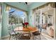 Bright breakfast nook with table and chairs offering views of the outdoor lanai at 1724 Amberwynd W Cir, Palmetto, FL 34221
