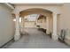 Covered driveway featuring an elegant archway with columns leading to the garage and house at 1724 Amberwynd W Cir, Palmetto, FL 34221