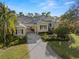 Charming single-Gathering home with beautiful landscaping, a brick driveway, and a well-manicured lawn at 1724 Amberwynd W Cir, Palmetto, FL 34221