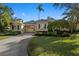 Well-maintained home featuring lush landscaping, brick driveway, and neutral color scheme at 1724 Amberwynd W Cir, Palmetto, FL 34221