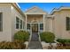 Beautiful front entrance featuring double doors, columns, manicured landscaping, and a brick walkway at 1724 Amberwynd W Cir, Palmetto, FL 34221