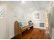 Hallway with bench seat, wooden floors, white walls and wainscoting and ocean themed decor at 1724 Amberwynd W Cir, Palmetto, FL 34221