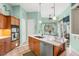 Gourmet kitchen features stainless appliances, a center island, and an adjacent breakfast nook with outdoor access at 1724 Amberwynd W Cir, Palmetto, FL 34221