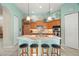Kitchen features a large center island, stainless appliances, and pendant lighting with breakfast bar seating at 1724 Amberwynd W Cir, Palmetto, FL 34221