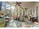 Spacious lanai with ample seating, ceiling fans, and views of the pool and lush landscaping at 1724 Amberwynd W Cir, Palmetto, FL 34221