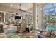 Comfortable lanai seating with lush views, ceiling fans, and pool access at 1724 Amberwynd W Cir, Palmetto, FL 34221
